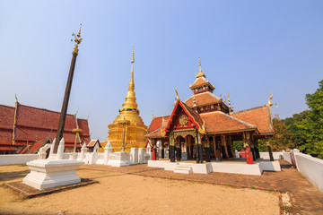 Fototapeta na wymiar Cruciform shaped pavilion and golden Buddhist pagoda