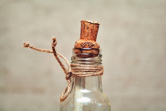 old glass bottle with a cork and rope