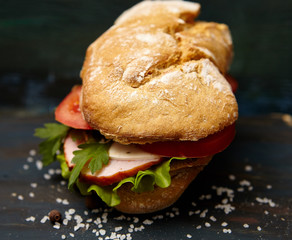  sandwich with ham and vegetables on dark wooden background
