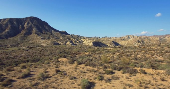 4K Aerial, Flight over a dry riverbed in a desert in Andalusia, Spain - Shot is additionally stabilized, graded and mostly accelerated. Watch also for the native versions