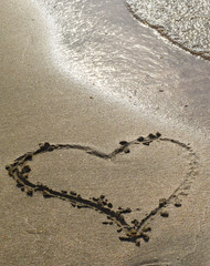 Heart drawn on the beach sand