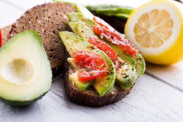 Tasty avocado sandwich with tomato and seasoning for slimming.