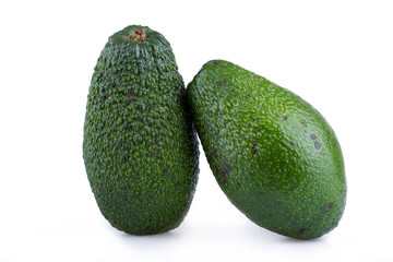 Two avocados isolated on a white background.
