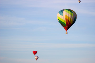 hot air balloon moving up in blue sky.