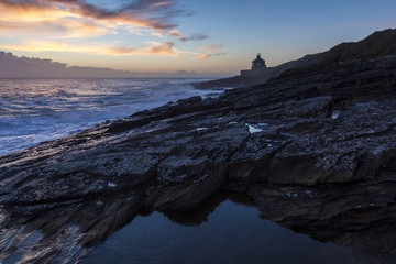 Sun rise on winter morning at Cullernose Point on the coast of Northumberland, England, UK.