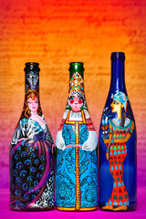bottle art, contemporary art. Decorative bottle depicting women in folk costumes, Russian, Egyptian, Spanish - 103776669