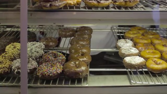 Slow tilt up of donuts in a bakery