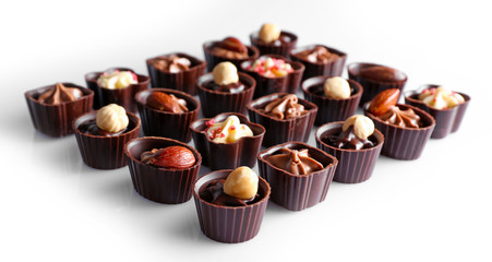 Delicious chocolate candies on white background