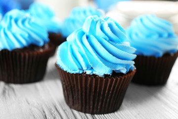 Blue cupcakes on wooden table