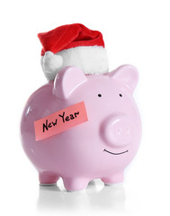 Piggy bank with Santa hat isolated on white