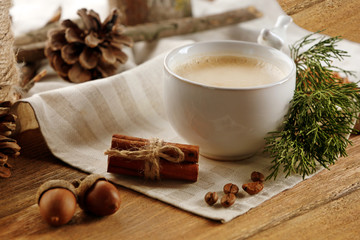 Obraz na płótnie Canvas Cup of coffee on napkin on wooden background