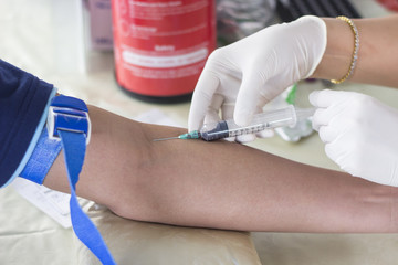 Nurse doing blood tests to check