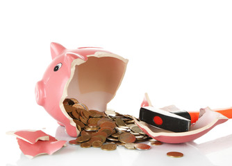 Piggy bank is broken by hammer isolated on white background