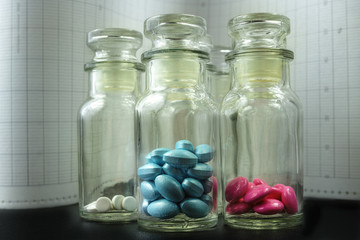 Glass bottles with colorful pills