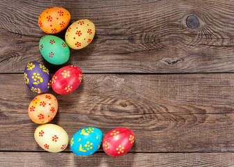 Multi-colored Easter eggs on the old board