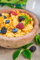 Healthy cornflakes with milk and berry fruits