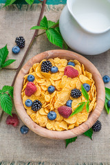 Sweet cornflakes with milk and berry fruits