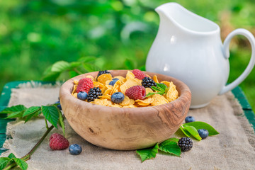 Sweet cornflakes with berry fruits and milk