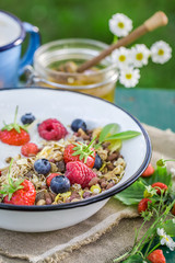 Tasty breakfast with yogurt and berry fruits in sunny day