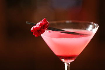 Glass of cocktail on bar background