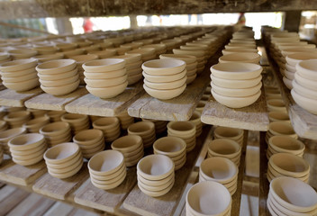 Ceramic cup in rack prepare for bring in furnace in factory
