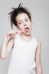 little girl brushing her teeth