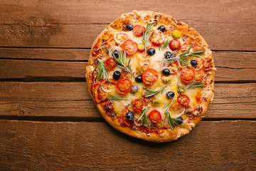 Delicious fresh pizza on wooden background