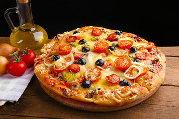 Delicious fresh pizza on black background