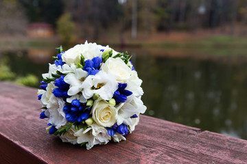 Beautiful wedding bouquet with blue and white flowers