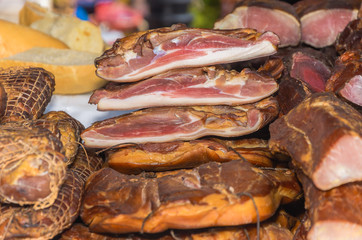 Smoked meat at the market with bread in background,closeup shoot,selective focus