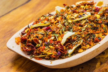 Colored spices for pasta mix on wooden spoon