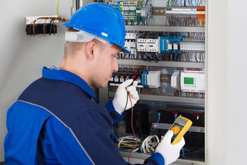 Male Technician Examining Fusebox