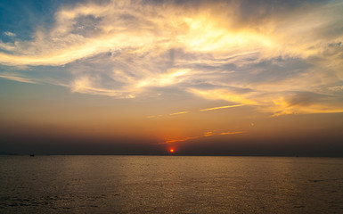 twilight sky with colorful sunset and clouds at beach