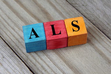 ALS (Amyotrophic Lateral Sclerosis) acronym on colorful wooden c