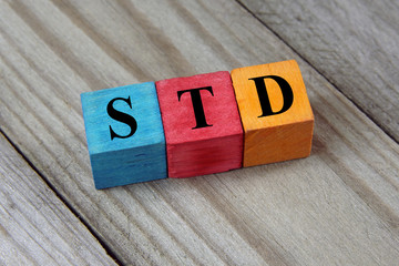 STD (Sexually transmitted infections) acronym on colorful wooden