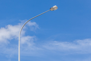 A street light pole with beautiful blue sky background.