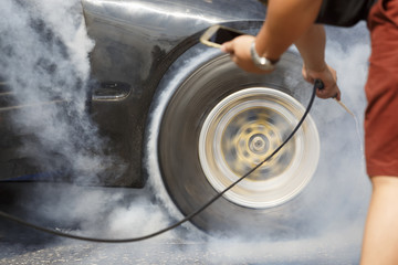 Drag racing car burns rubber off its tires 