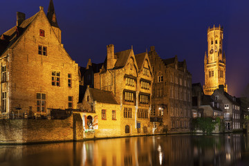 Belfry of Bruges reflected in the canal