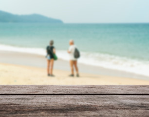 Fototapeta na wymiar Wood table top on blurred blue sea and white sand beach