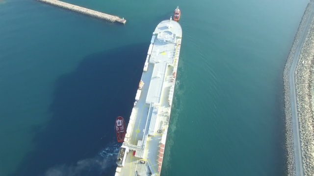 Aerial view of cargo ship entering the port in Bar city