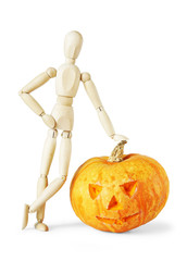 Man leaned against a giant Halloween pumpkin. Abstract image with a wooden puppet