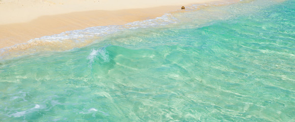 Soft wave of the tropical sea on the sandy beach. Caribbean Sea