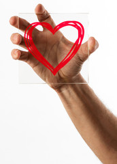 Heart symbol on glass over white background