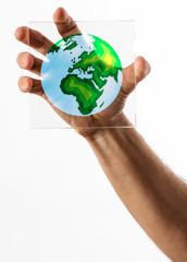Planet Earth symbol on glass over white background