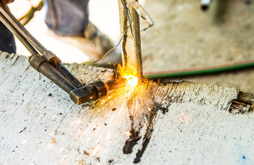 Metal Cutting With Gas. Workman is working by use torch cut the iron in factory. Spark splash...
