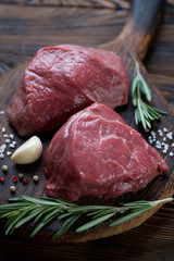 Close-up of raw filet mignon beefsteaks with seasonings