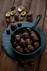 Still life with roasted chestnuts in a frying pan, studio shot