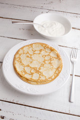 homemade pancakes pancakes on a plate with sour cream on wood ta