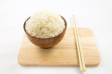 Bowl of rice and chopsticks on wooden isolated on white