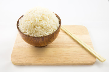 Bowl of rice and chopsticks on wooden isolated on white